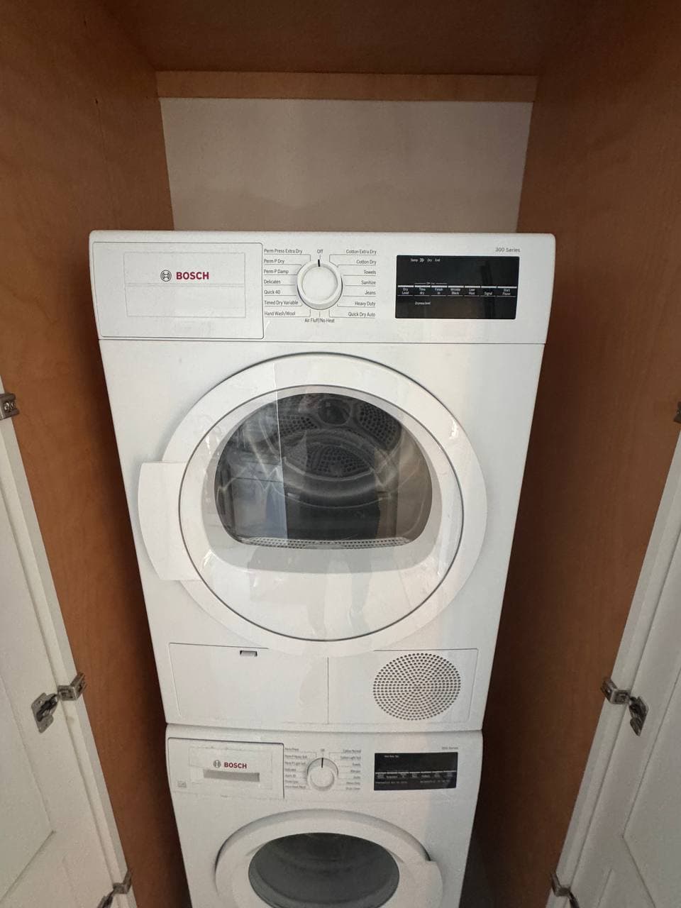 Washer Repair by Same Day Appliance Fix — Palm Beach County FL | Call $<span className="tabular">{BUSINESS.phone}</span> Bosch stacked washer and dryer unit repaired in compact Palm Beach County laundry closet